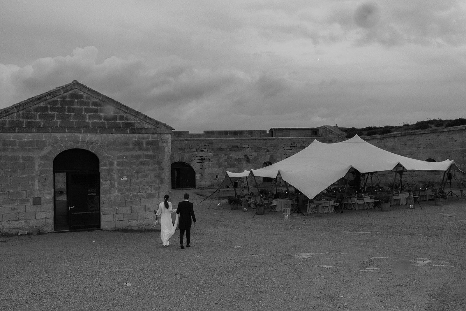 Bride And groom walking towards the dinner area at sunset, taken by Sus Pons Menorca Wedding Photographer