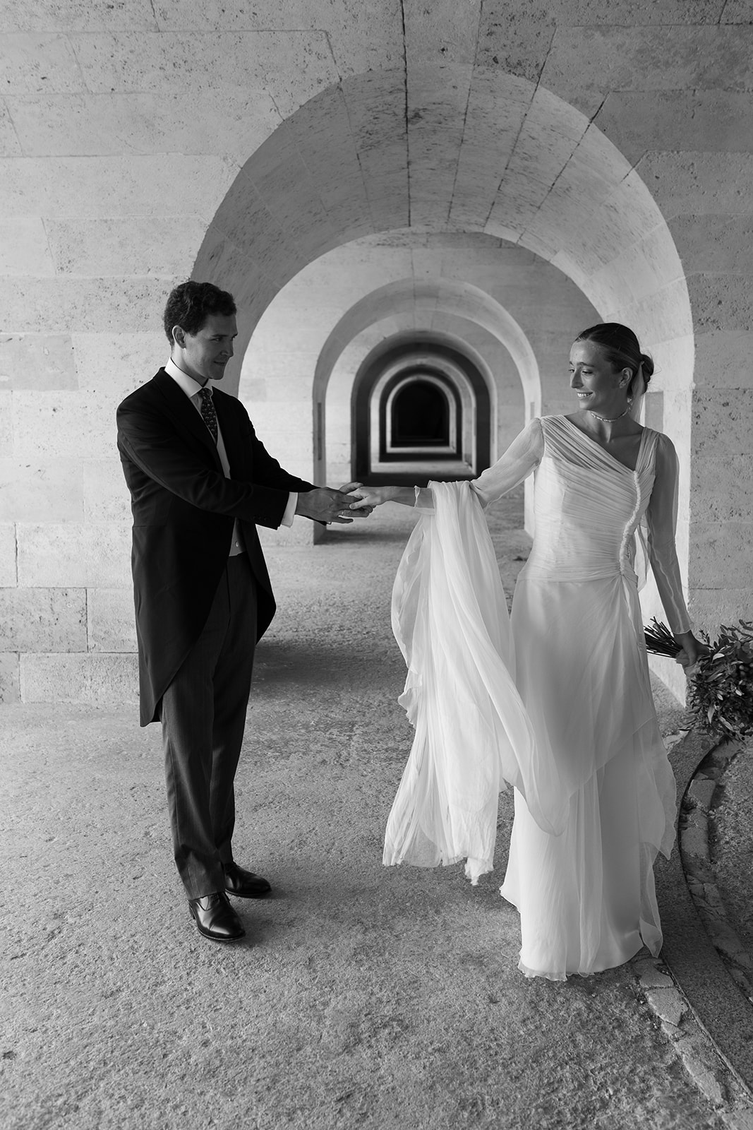 Bride and groom stands at La Mola Menorca captured by Menorca wedding photographer Sus Pons.